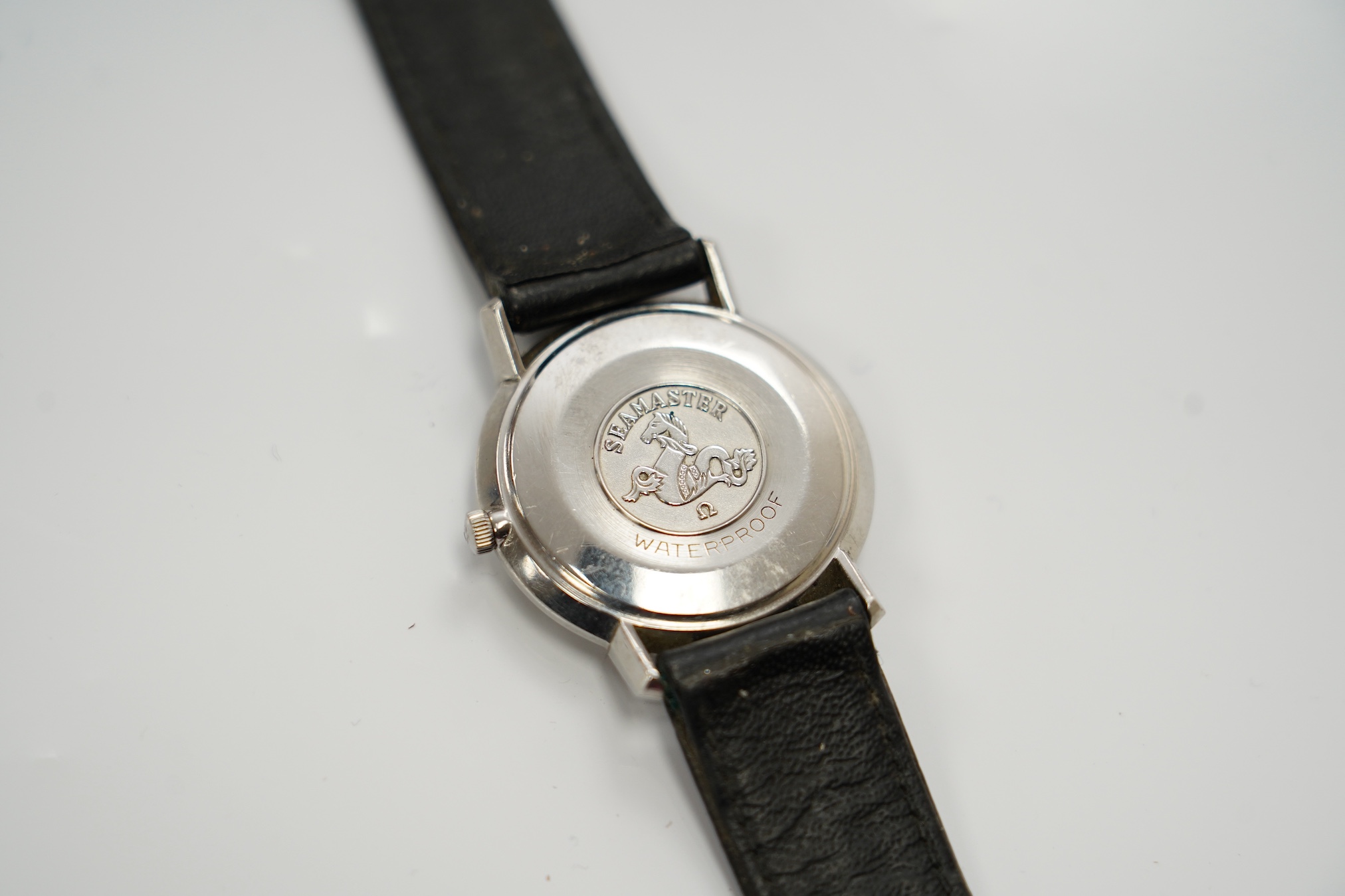 A gentleman's stainless steel Omega Seamaster DeVille manual wind wrist watch, on associated leather strap, case diameter 34mm. Condition - poor